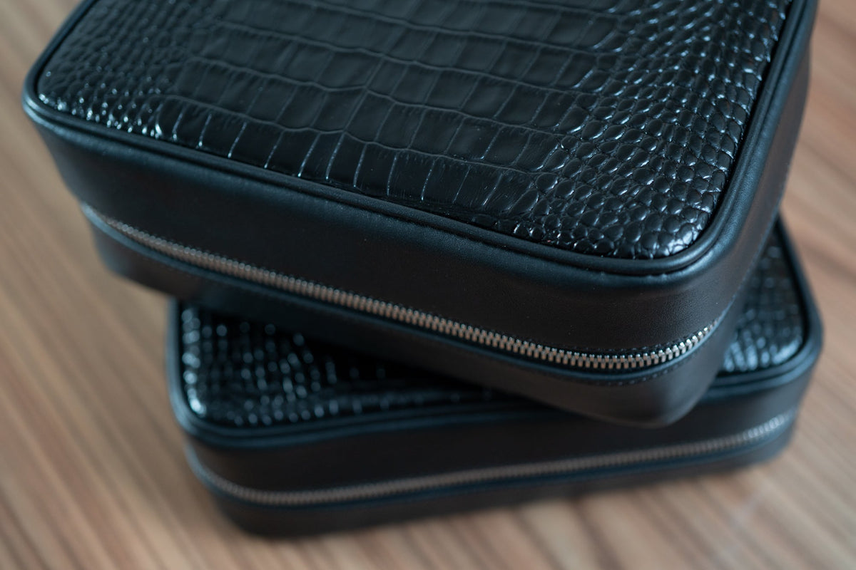 two black leather luxury cases for traveling with premium cigars and luxury accessories.