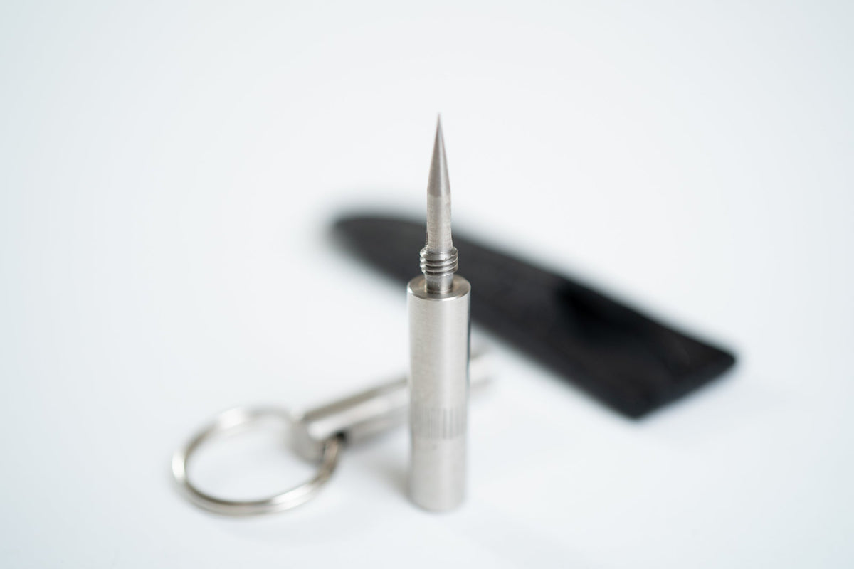 "Trilogy" Cigar Punch . Silver tool with pointed triangle top